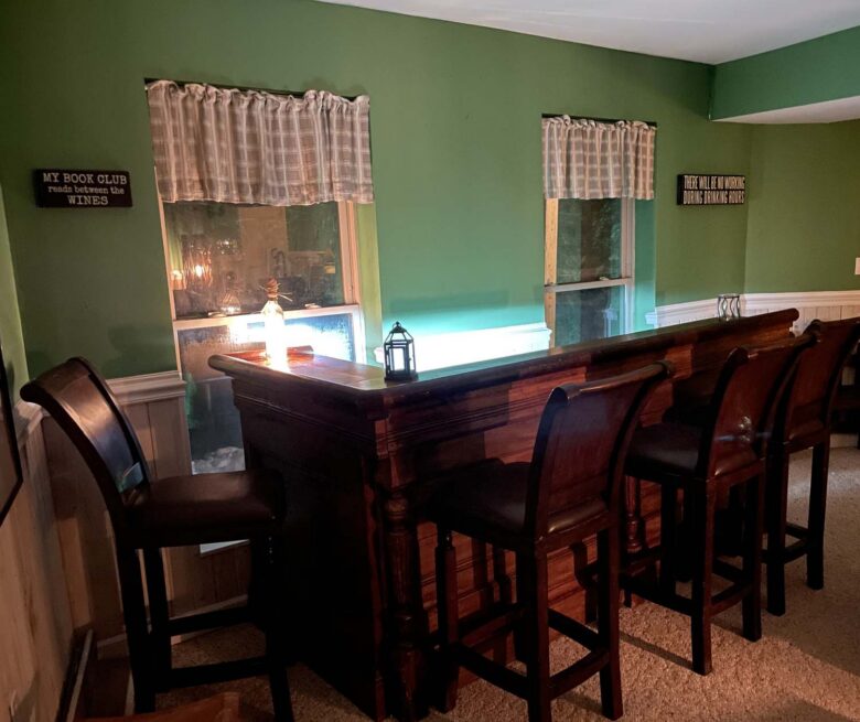 The antique bar with its stools, lit at night