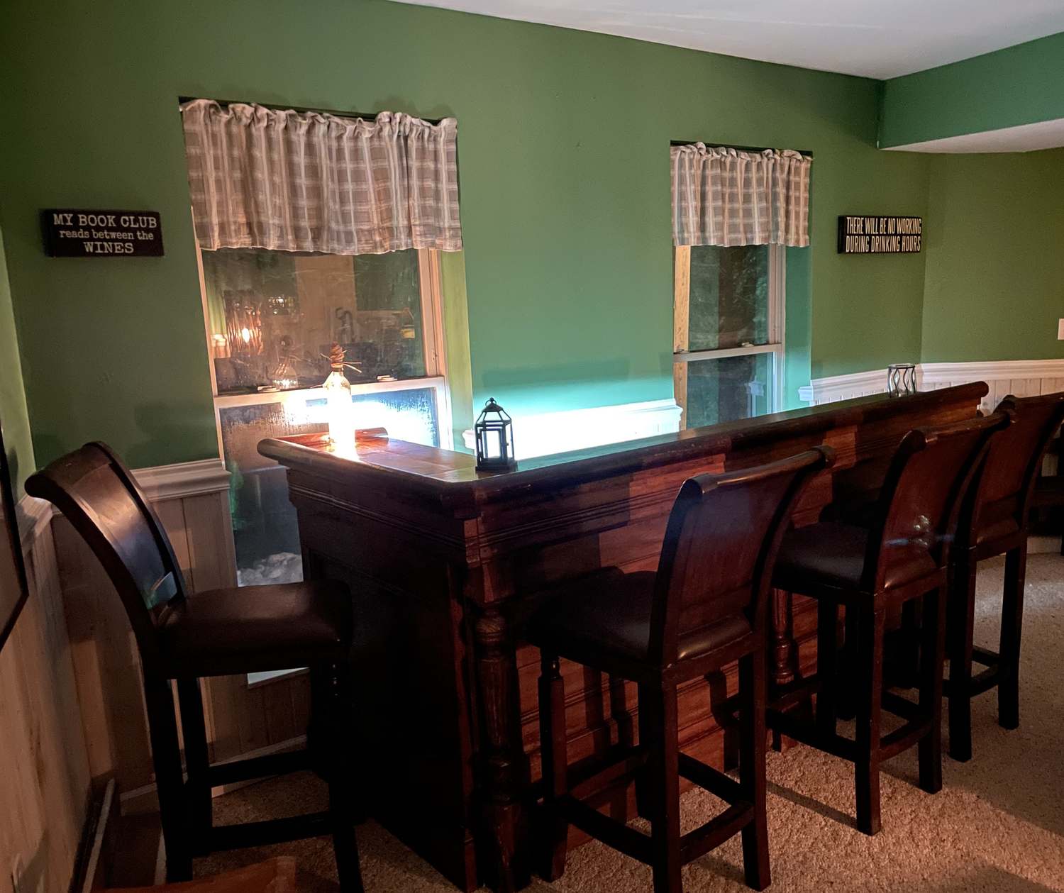 The antique bar with its stools, lit at night