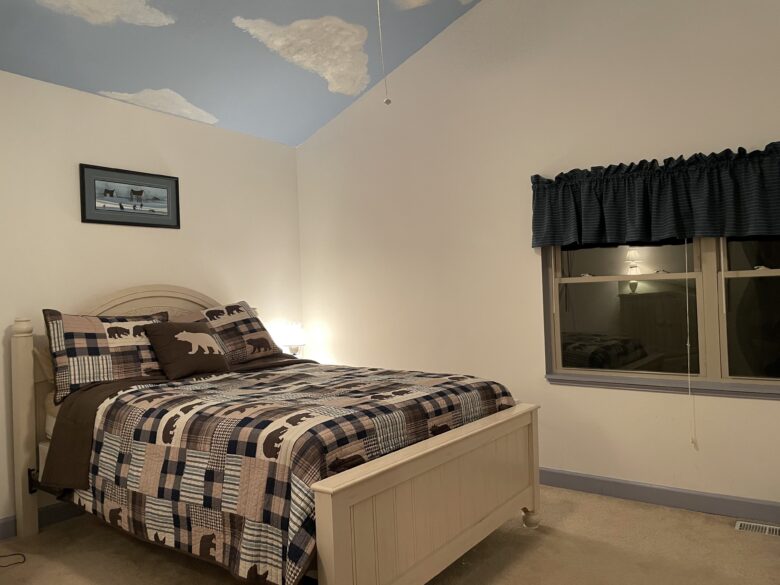 The Clouds and Woods View Room: queen bed under a sky painted on the ceiling