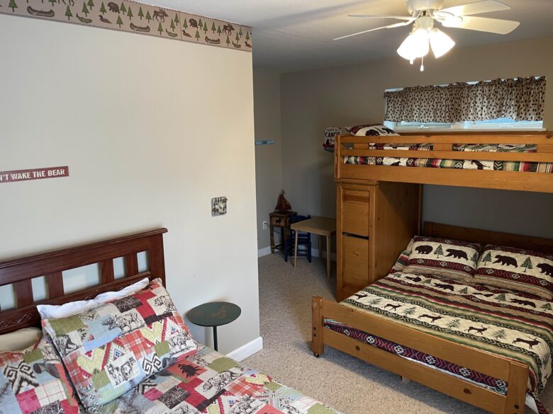 The Downstairs Bunk and Queen Room, with the queen bed in the foreground