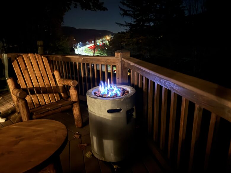 The gas fire table burning on the deck at night
