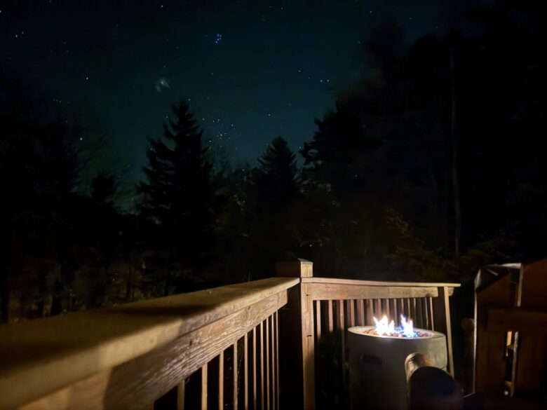 The gas fire table burning on the deck under a clear night sky