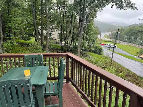 The green table on the deck, looking down through the trees