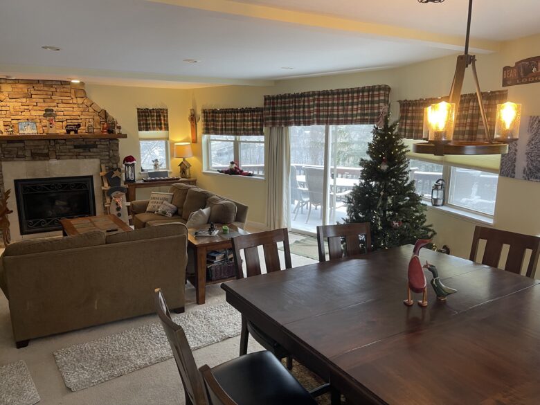 The dining area open to the living room and fireplace