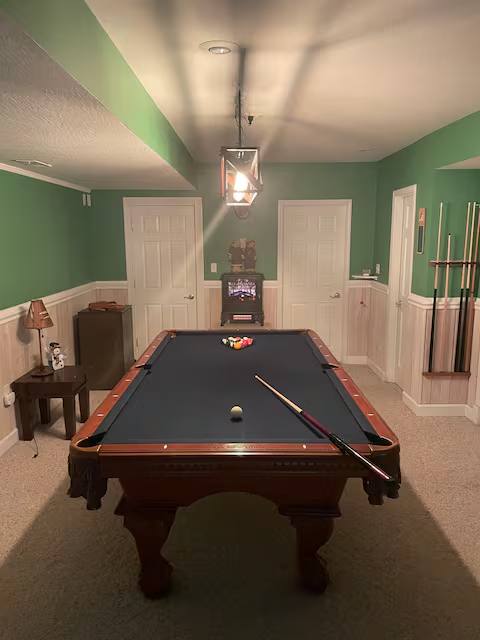 The full-size pool table in the lower-level game room