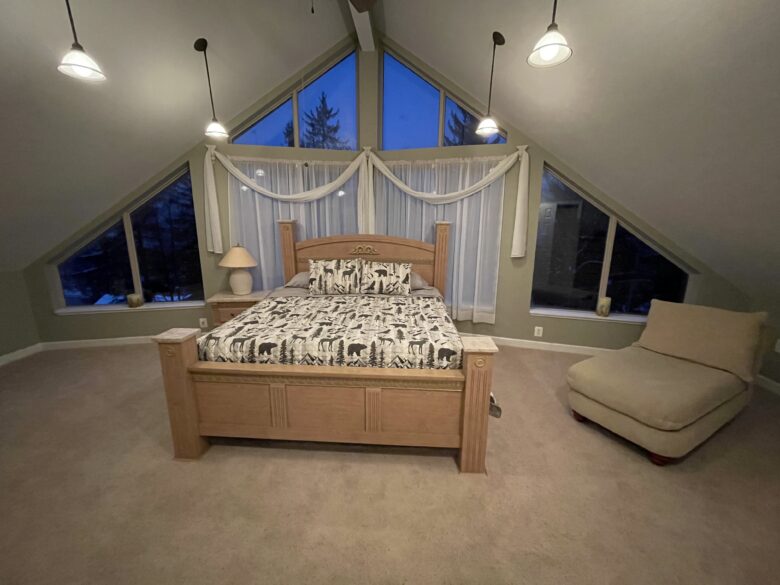 The Upstairs Master Suite: king bed under a cathedral ceiling with A-frame windows